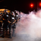 Charlotte-Mecklenburg, N.C., police officers in riot gear stand in a haze of tear gas watching protesters on Old Concord Road on Sept. 20, 2016, in Charlotte, N.C.
Jeff Siner/Charlotte Observer/TNS via Getty Images